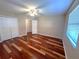 Bedroom with hardwood floors, ceiling fan and natural light at 600 Caribbean Dr, Lakeland, FL 33803