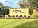 Welcoming Villas by the Lake community sign amidst a beautifully landscaped entrance at 600 Caribbean Dr, Lakeland, FL 33803