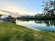 Beautiful waterfront sunset view showcasing a tranquil lake and lakeside gazebo at 600 Caribbean Dr, Lakeland, FL 33803