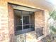 Welcoming screened entryway featuring classic brickwork and decorative iron accents at 600 Caribbean Dr, Lakeland, FL 33803