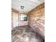 Covered entryway with brick facade, tiled flooring, and protected doorway at 600 Caribbean Dr, Lakeland, FL 33803