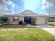 Charming single-story brick home with a well-manicured lawn and a neatly paved driveway at 600 Caribbean Dr, Lakeland, FL 33803