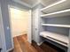 Hallway including built-in shelves and a desk, leading to a walk-in closet at 600 Caribbean Dr, Lakeland, FL 33803
