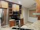 Spacious kitchen with stainless steel refrigerator, oven and glass front cabinets at 600 Caribbean Dr, Lakeland, FL 33803