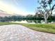 The brick patio overlooks a scenic lake, offering a serene outdoor living space at 600 Caribbean Dr, Lakeland, FL 33803