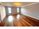Bright living room featuring two large windows and hardwood flooring at 600 Caribbean Dr, Lakeland, FL 33803