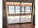 View through sliding glass doors onto sun-drenched patio with tiled floors at 600 Caribbean Dr, Lakeland, FL 33803
