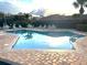 Community pool featuring a brick-paved deck and comfortable lounge seating at 600 Caribbean Dr, Lakeland, FL 33803