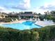 Community pool surrounded by lounge chairs, perfect for relaxing by the water at 600 Caribbean Dr, Lakeland, FL 33803