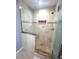 Shower with upgraded tile, built-in niche and glass doors at 600 Caribbean Dr, Lakeland, FL 33803