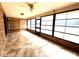 A bright sunroom featuring tile floors, brick walls, and expansive windows, creating a relaxing and inviting atmosphere at 600 Caribbean Dr, Lakeland, FL 33803