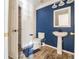 Bathroom featuring wood-look tile flooring, a pedestal sink, toilet, and bold wall color at 6011 Placid Pass, Lakeland, FL 33805