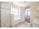 Bright bathroom with tile flooring, a shower, a tub, and a view of the bedroom from the doorway at 6011 Placid Pass, Lakeland, FL 33805