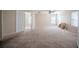 Spacious carpeted bedroom with an open doorway to another room at 6011 Placid Pass, Lakeland, FL 33805