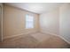 Cozy bedroom featuring neutral walls, plush carpeting, and a window for natural light at 6011 Placid Pass, Lakeland, FL 33805