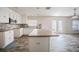 Bright kitchen featuring white cabinets, an island, stone countertops, and stainless steel appliances at 6011 Placid Pass, Lakeland, FL 33805