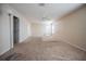 Large living room with neutral carpet, a ceiling fan, and lots of natural light from the many windows at 6011 Placid Pass, Lakeland, FL 33805