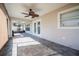 This bright sunroom features tiled floors, a ceiling fan, and sliding doors leading to the outside patio area at 6011 Placid Pass, Lakeland, FL 33805