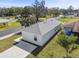 Aerial view of a single-story house with a gray roof and a small yard at 629 7Th W St, Lakeland, FL 33805