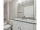 Updated bathroom with granite countertop, white cabinets, and tiled shower at 629 7Th W St, Lakeland, FL 33805