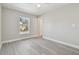 Bedroom with grey flooring, window, and ceiling fan at 629 7Th W St, Lakeland, FL 33805
