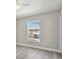 Spacious bedroom with large window and ceiling fan at 629 7Th W St, Lakeland, FL 33805