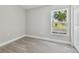 Bright bedroom featuring gray laminate flooring and a window at 629 7Th W St, Lakeland, FL 33805