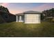 Newly built house with a screened porch and a well-maintained lawn at 629 7Th W St, Lakeland, FL 33805