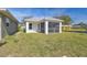 Charming new house with a spacious screened porch and a green lawn at 629 7Th W St, Lakeland, FL 33805