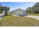 House exterior showcasing a side view and grassy lawn at 629 7Th W St, Lakeland, FL 33805