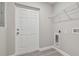 Laundry room with built-in shelving and exterior access at 629 7Th W St, Lakeland, FL 33805