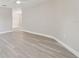 Gray vinyl flooring and neutral walls in this spacious living room at 629 7Th W St, Lakeland, FL 33805