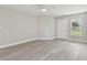 Open living room with gray vinyl plank flooring and plenty of natural light at 629 7Th W St, Lakeland, FL 33805