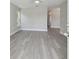 Bright living room with gray vinyl flooring and ceiling fan at 629 7Th W St, Lakeland, FL 33805