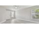 Living room with gray vinyl flooring, neutral walls, and a ceiling fan at 629 7Th W St, Lakeland, FL 33805