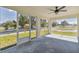 Relaxing screened porch with ceiling fan and view of the street at 629 7Th W St, Lakeland, FL 33805