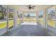 Spacious screened porch with concrete flooring, ceiling fan, and views of the street at 629 7Th W St, Lakeland, FL 33805