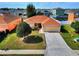 Inviting single-story home boasting a manicured lawn, neutral exterior, and an attached garage at 6610 Crescent Loop, Winter Haven, FL 33884