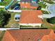 An aerial shot showcases the home's backyard, screened patio, and proximity to neighborhood amenities at 6610 Crescent Loop, Winter Haven, FL 33884