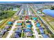 Aerial view of a residential neighborhood featuring single-Gathering homes, tree lined streets, and community amenities at 6610 Crescent Loop, Winter Haven, FL 33884