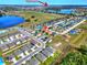 Aerial view of a residential neighborhood near a lake, featuring single-Gathering homes and community amenities at 6610 Crescent Loop, Winter Haven, FL 33884