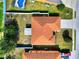 Aerial view of a charming single-Gathering home featuring a screened pool and well-maintained backyard with a fire pit at 6610 Crescent Loop, Winter Haven, FL 33884