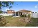 Serene backyard featuring a screened-in lanai and established landscaping at 6610 Crescent Loop, Winter Haven, FL 33884