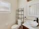 Bathroom featuring vessel sink, shelving and window providing natural light at 6610 Crescent Loop, Winter Haven, FL 33884