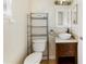 Bathroom featuring vessel sink, shelving and window providing natural light at 6610 Crescent Loop, Winter Haven, FL 33884