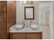 Bathroom boasting dual vessel sinks with stylish faucets set on marble counter-top at 6610 Crescent Loop, Winter Haven, FL 33884