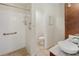 Bathroom featuring walk-in shower with safety bar, white tiled walls, and elegant sink at 6610 Crescent Loop, Winter Haven, FL 33884