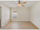 A bright bedroom features neutral paint, tile floors, and a ceiling fan at 6610 Crescent Loop, Winter Haven, FL 33884
