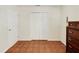Bedroom featuring tile floors and a double door closet for storage and convenience at 6610 Crescent Loop, Winter Haven, FL 33884