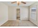 Bright bedroom featuring tiled floors, ceiling fan and window for ample natural lighting at 6610 Crescent Loop, Winter Haven, FL 33884